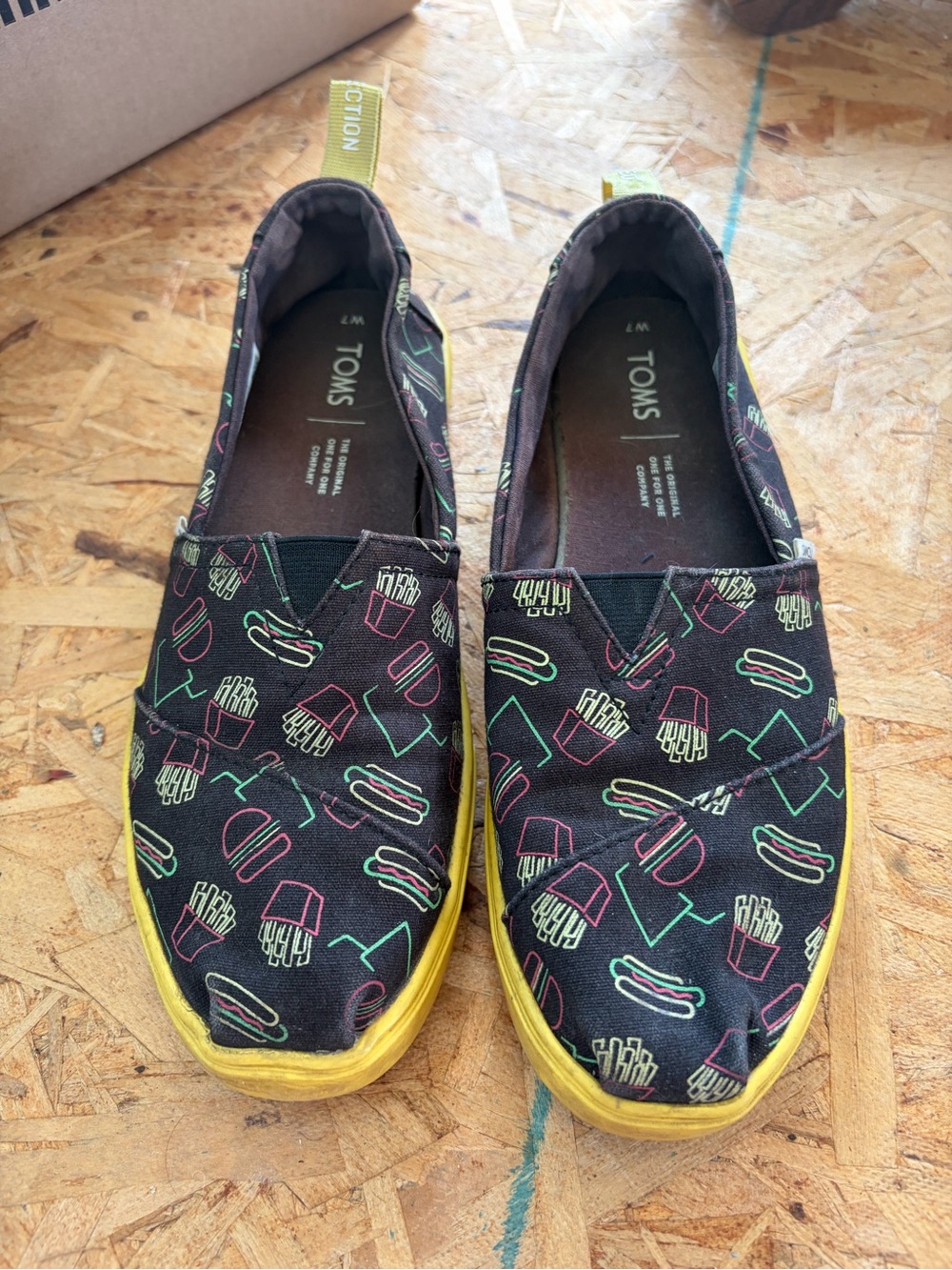 TOMS Black Sneaker-Style Slip-Ons with Yellow Sole & Neon Snack Print